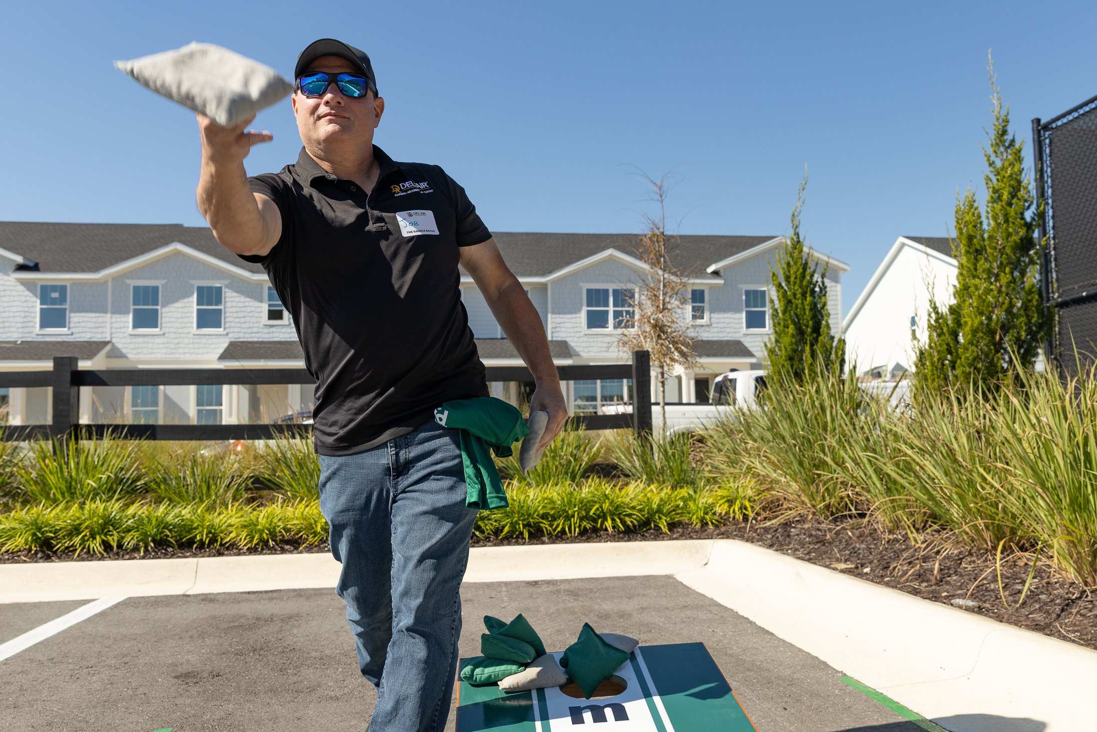 A player tosses a beanbag during the HomeAid Orlando Cornhole Tournament.
